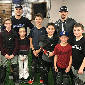 Coach Mitch and Coach Joel with students at a catching clinic