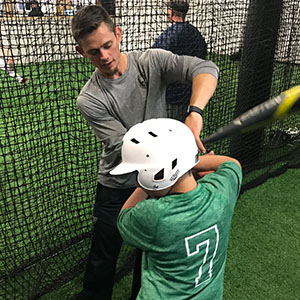 Brent works on batting form with a member of the Woodinville Little League