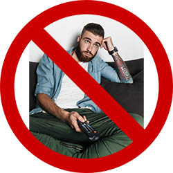 Guy on couch with TV remote covered by big, red, cross out circle