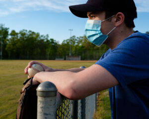 Waiting with Face Mask to Play Baseball