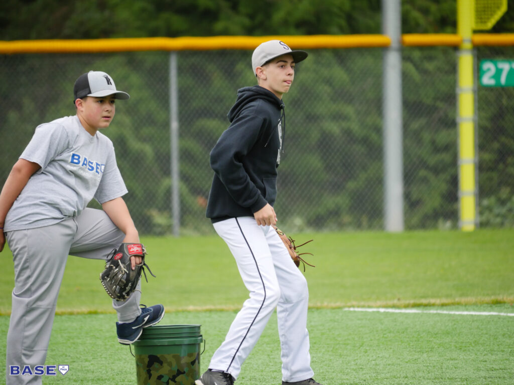 Two boys fielding grounders at summer camp