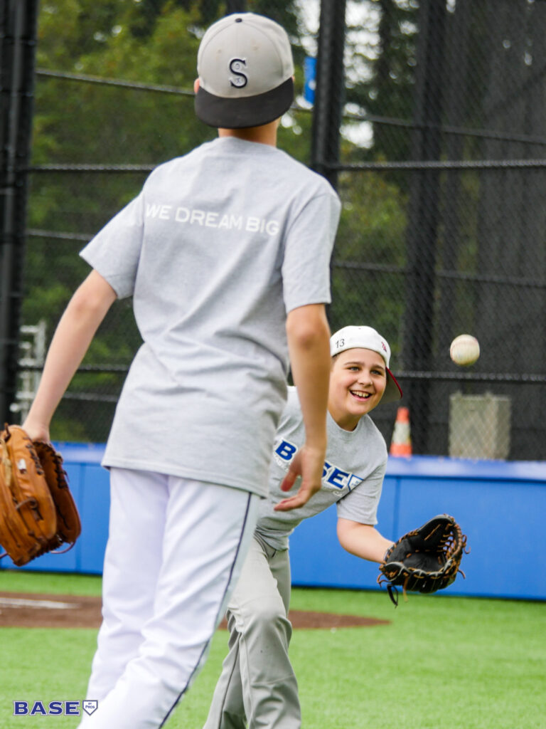 Two boys playing catch at summer camp