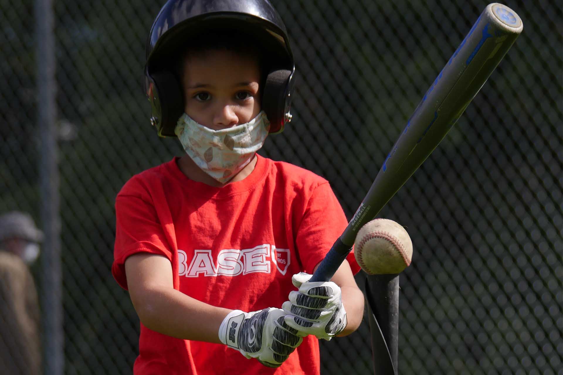 Boy Preparing to Hit at Batting Tee