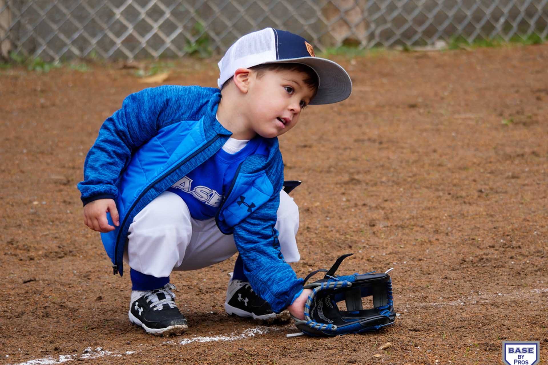 Little Boy Prepares to Field a Baseball