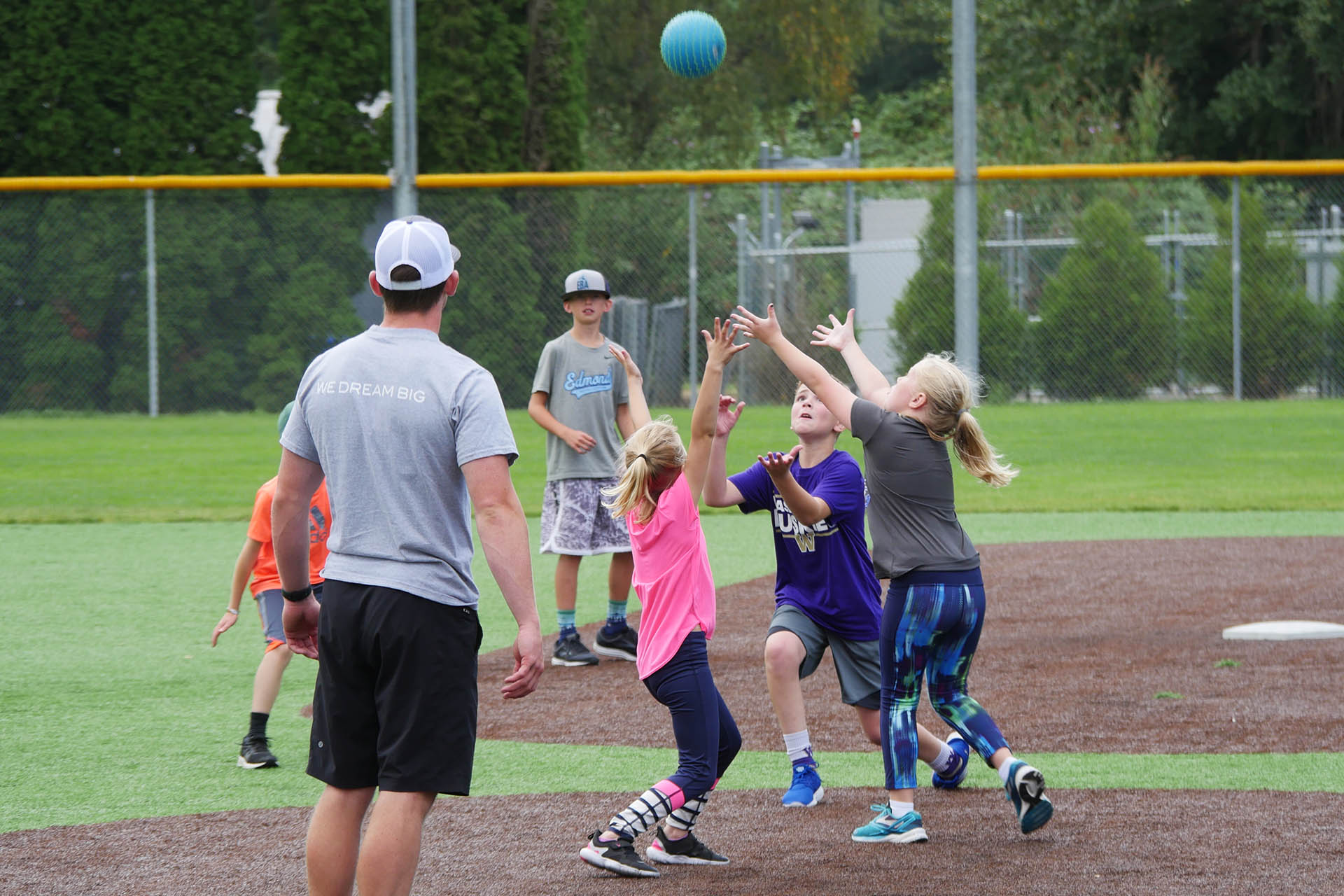 Kids competing at camp to catch a kickball