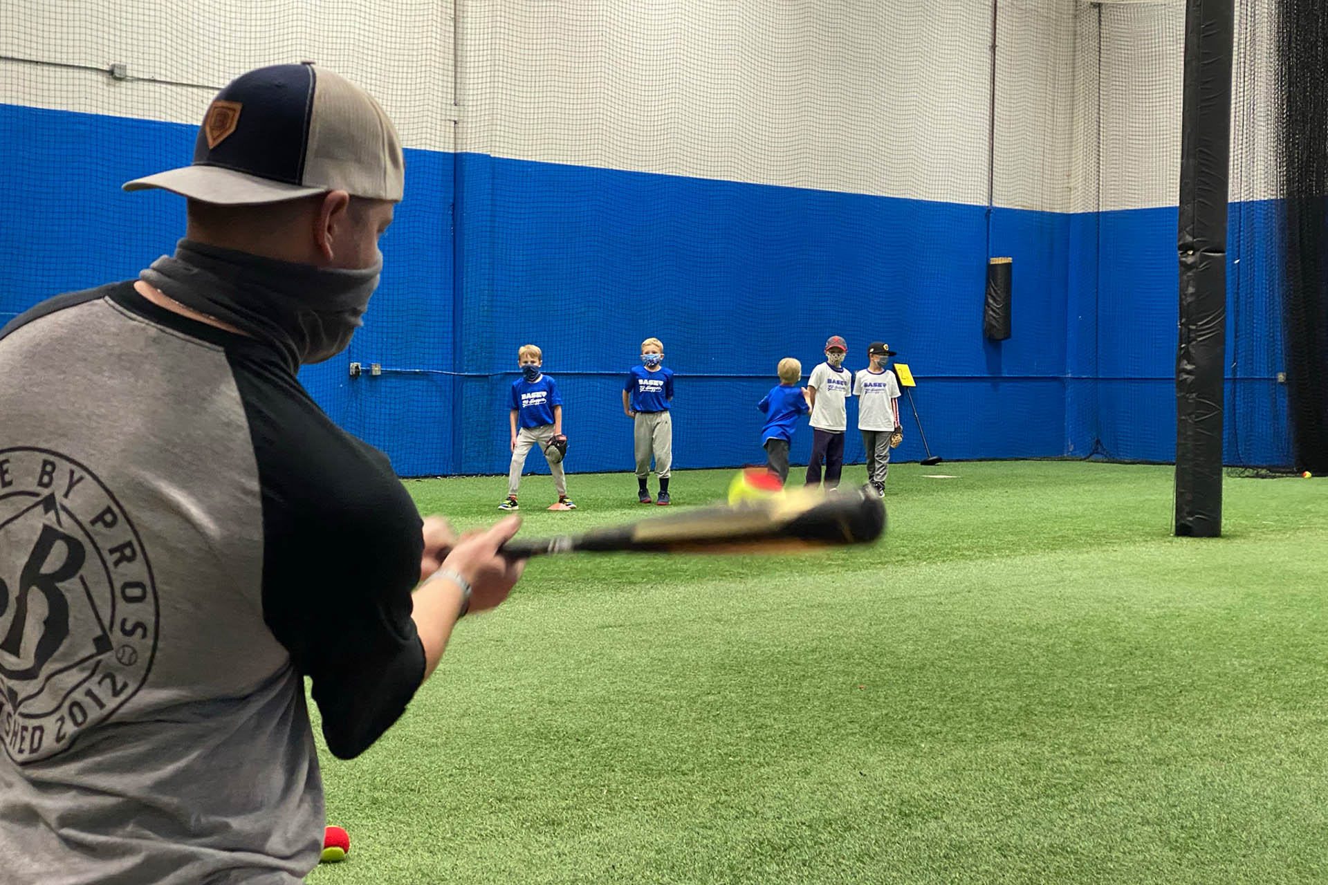 Hitting Tennis Balls to Young Baseball Fielders