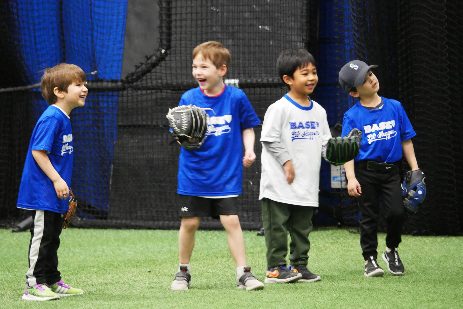 Boys with baseball mitts laughing