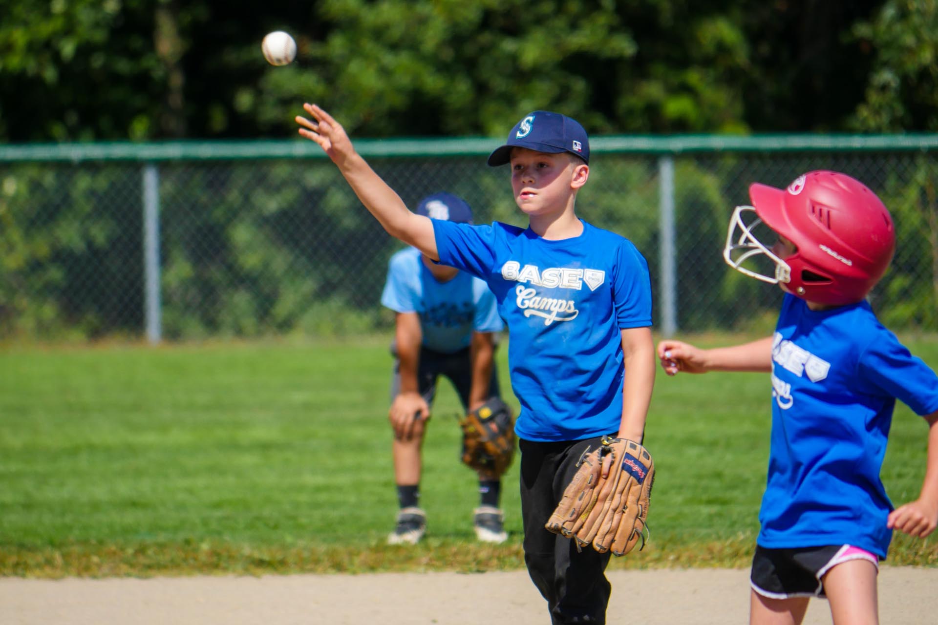 Boy Throws Baseball at Summer Camp