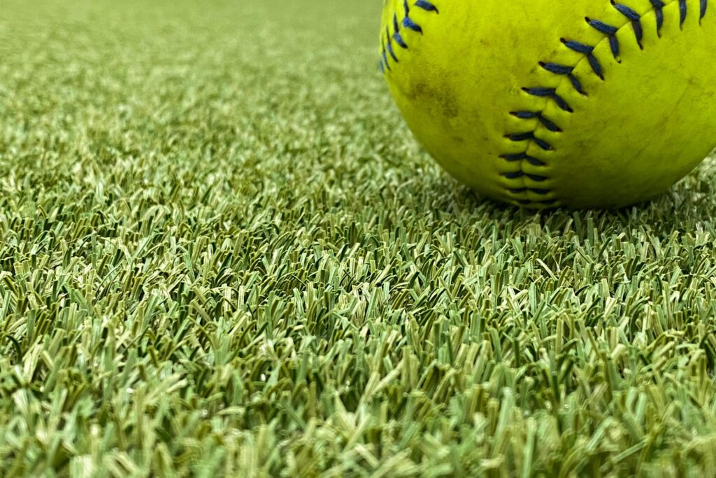 Softball Lying on Turf