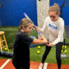 Coach Autumn Works with a Softball Hitter