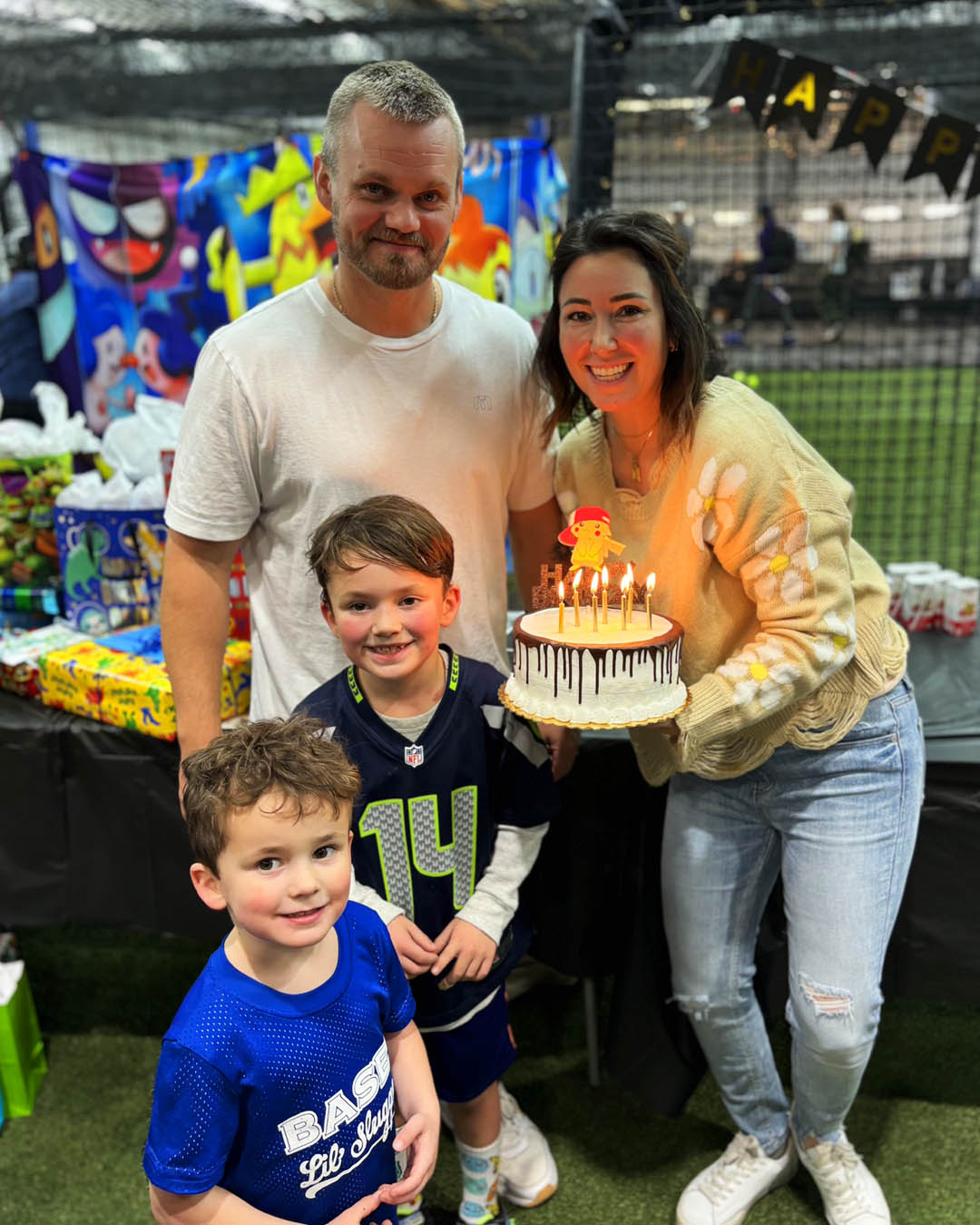 Family with a birthday cake at BASE by Pros in Lynnwood