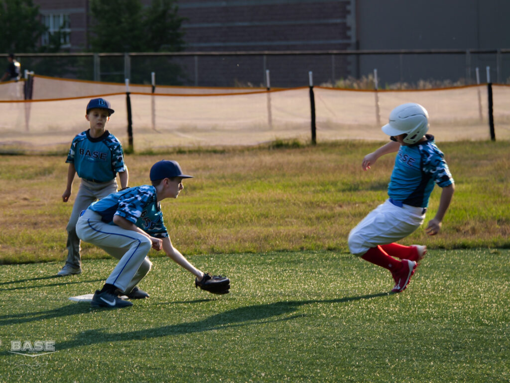 A shortstop applies the tag on a baserunner at Summer Sluggers 2023