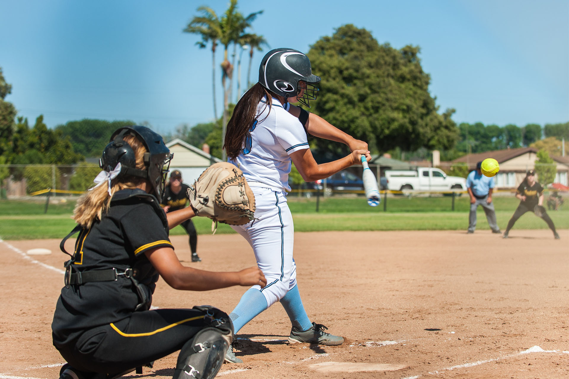 Softball Players Swings at Pitch